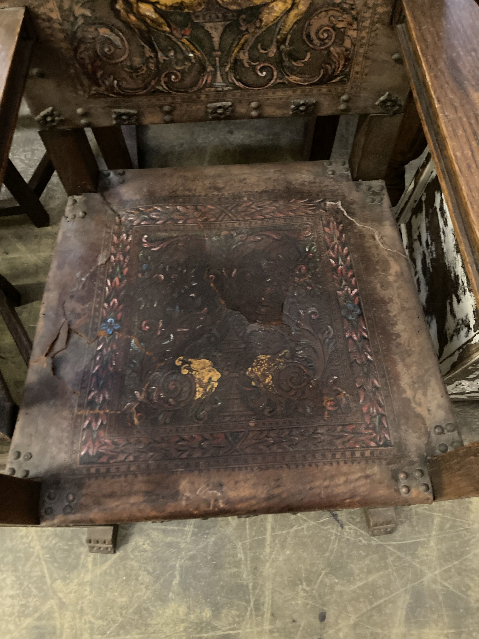 A pair of Spanish oak elbow chairs, width 62cm, depth 52cm, height 128cm